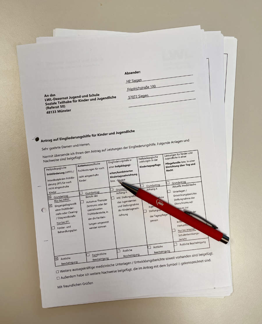 Mehre Blätter bedrucktes Papier, auf dem Papierstapel liegt ein Kugelschreiber